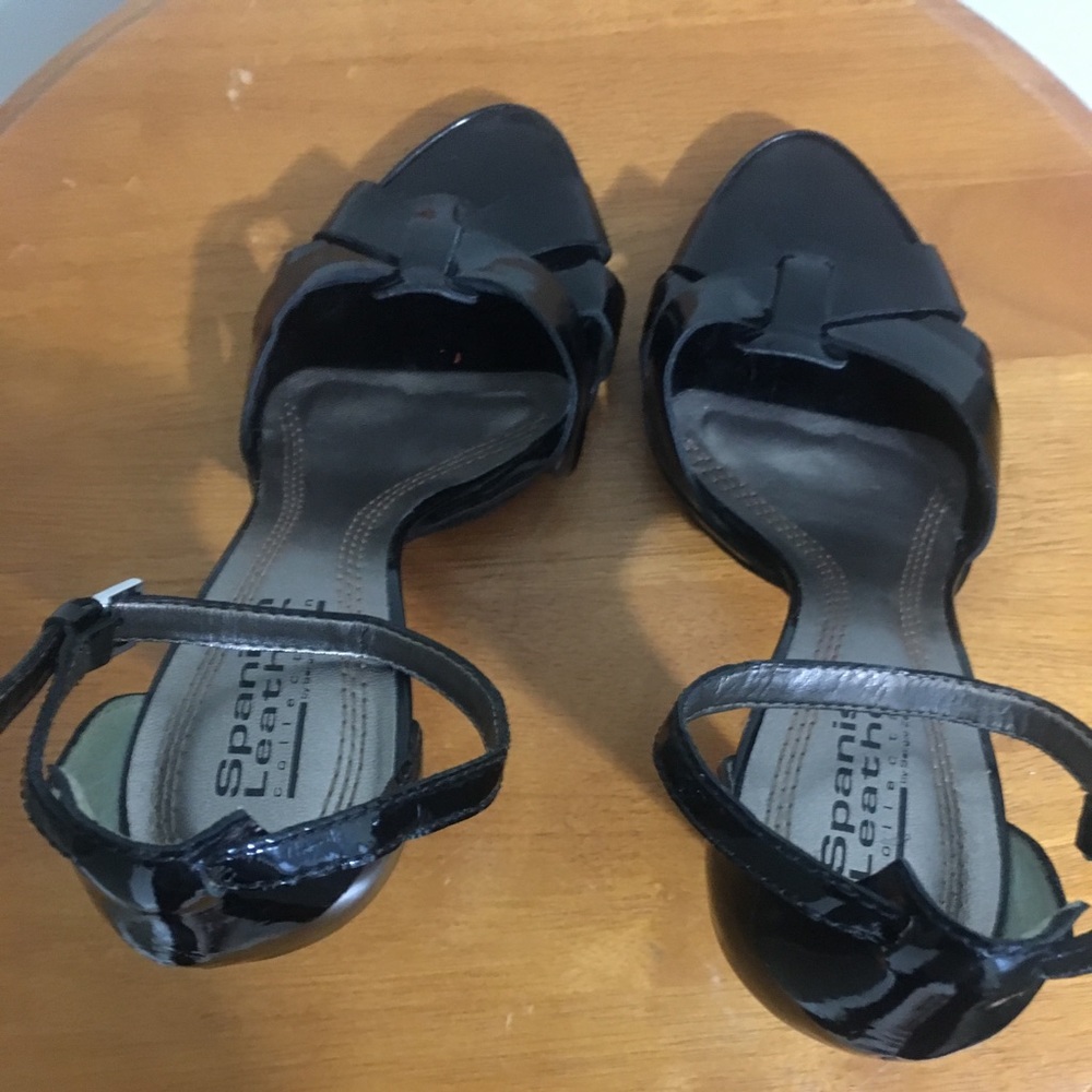 Black patent peep-toe, high heel shoes.